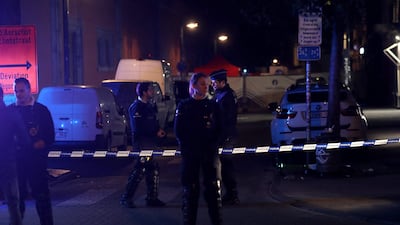 Police stand guard at the scene of the stabbing attack in Brussels on Thursday. AFP