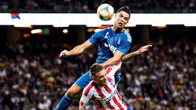 Ronaldo wins an aerial tussle with Kieran Trippier. AP