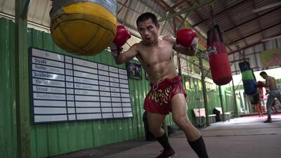 World Boxing Council (WBC) mini-flyweight champion, Wanheng Menayothin, punching a bag during a training session in Bangkok. Lillian Suwanrumpha / AFP