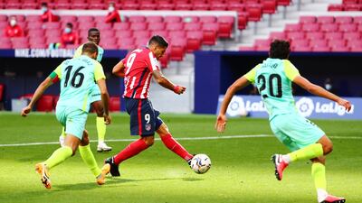 Luis Suarez shoots to score Atletico's sixth goal against Granada. Reuters
