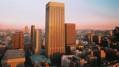 The Johannesburg skyline. Attempts to wipe away the legacy of apartheid in South Africa have failed to narrow the imbalance between the rich and the poor, with 3,500 adults owning more than the poorest 32 million people in the country. Alamy
