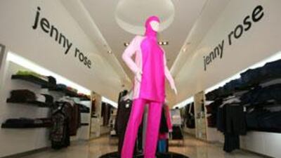 Marina Alfaro arranges a MyCozzie swimsuit on a mannequin at the Jenny Rose store in Dubai.