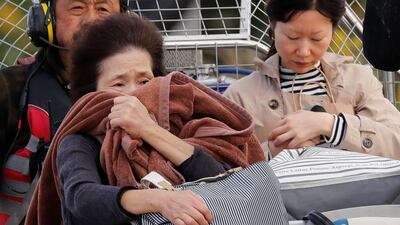 A woman reacts after she was rescued from a flooded area in the aftermath of Typhoon Hagibis, which caused severe floods at the Chikuma River in Nagano Prefecture, Japan. Reuters