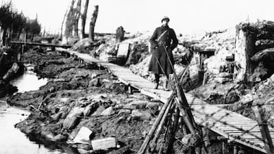 A soldier walks along wooden planks placed over the mud of Flanders' Fields near the Yperlee Canal near Ypres, Belgium.