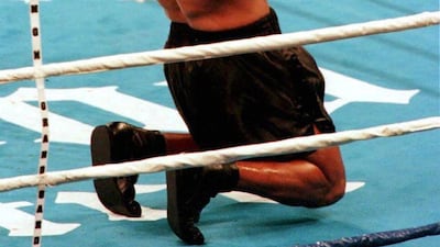 Mike Tyson celebrates after stopping Frank Bruno.