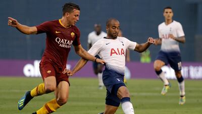 Tottenham's Lucas Moura holds off Roma's Luca Pellegrini. AP Photo