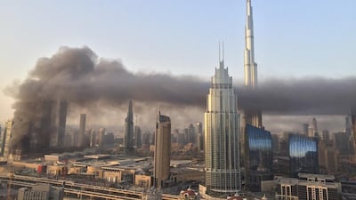 The smoke is carried across the Dubai sky in front of the Burj Khalifa. Courtesy Nikolett Scholtz