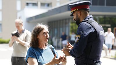 Graz Mayor Elke Kahr talks to a police officer. AFP
