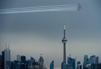 The Canadian Snowbirds circle the CN Tower as part of Operation Inspiration on May 10, 2020. AP