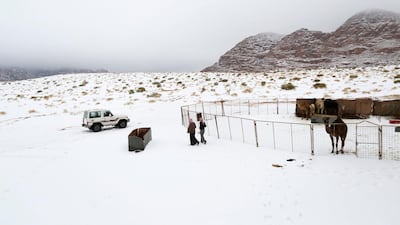 Saudis walk over snow after a heavy snowstorm in the desert near Tabuk, northwest of Riyadh February 21, 2015. Reuters
