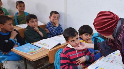 Sheikha Jawaher speaks to children in a refugee camp in Jordan. Welfare of the young is a huge concern. Courtesy NNC