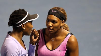 Venus Williams, left, and younger sister Serena fell a little short as doubles partners earlier this week in Dubai. They could find themselves on opposite sides of the net in Saturday’s singles final. Warren Little / Getty Images