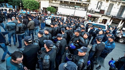 Algerian security forces stand in a street ahead of an approaching demonstration in the centre of the Algerian capital Algiers. AFP