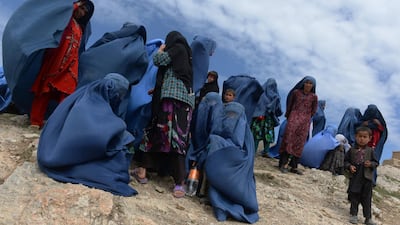 Villagers are pictured near the scene in the landslide-hit Aab Bareek village in Argo district of Badakhshan province. May 5, 2014. Shah Marai / AFP