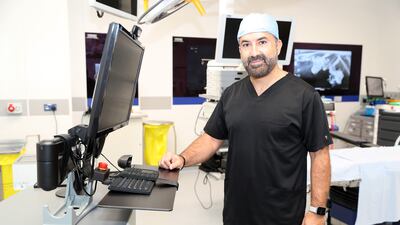 Professor Rabii Madi with the Sonablate machine. Pawan Singh / The National