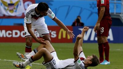 Thomas Muller, down, of Germany celebrates after scoring Germany's final goal in a 4-0 win over Portugal at the 2014 World Cup on Monday. Guillaume Horcajuelo / EPA