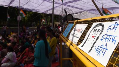Placards are placed on a police barricade in New Delhi on April 13, 2018 as Indian women protest against two recent rapes of young girls. Money Sharma / AFP