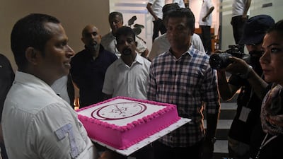 Supporters of President-elect Anura Kumara Dissanayake celebrate the NPP candidate's victory with a cake. Reuters