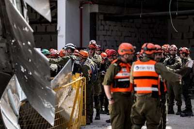 A gathering at the site of an Iranian strike in Yehud, central Israel. AFP