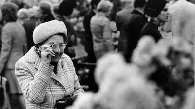 A visitor closely examines some blooms in 1972