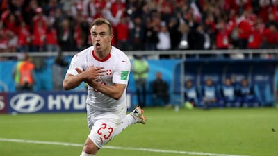 Xherdan Shaqiri celebrates after scoring Switzerland's late winner against Serbia. He plays with the Kosovo flag on his right boot. Martin Diviseck / EPA