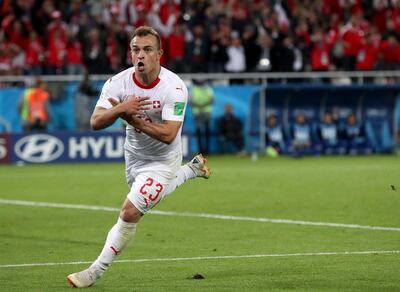 Xherdan Shaqiri celebrates after scoring Switzerland's late winner against Serbia. He plays with the Kosovo flag on his right boot. Martin Diviseck / EPA