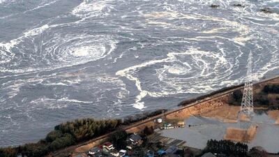 Whirlpools are seen following a tsunami and earthquake in Iwaki city, Fukushima Prefecture, in this March 11, 2011 Yomiuri file photo. Japan marked a month on Monday since the magnitude 9.0 earthquake and tsunami that killed thousands and created an ongoi???