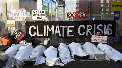 Activists from the climate change group Extinction Rebellion pretend to be dead under white sheets as they hold a 'Remember climate death' sit-in on the sidelines of Cop26. AFP