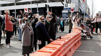 Supporters of the mosque shooting victims wave outside the Christchurch High Court during the sentencing hearing for Australian Brenton Tarrant, in Christchurch, New Zealand. AP Photo