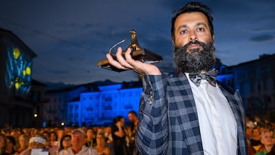 Sina Ataeian Dena, producer of Mantagheye bohrani (Critical Zone), accepts the Golden Leopard at the Locarno International Film Festival on behalf of director Ali Ahmadzadeh. EPA
