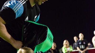 Luke Romano shows a youngster how to lead with his shoulder. Duncan Chard for The National