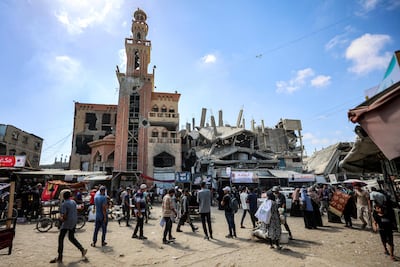 Gazans outside the heavily damaged Al Farouq mosque in Khan Younis. AFP
