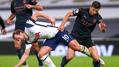 Spurs attacker Harry Kane and City defender Ruben Dias battle for possession. EPA
