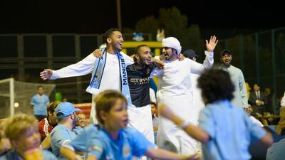 Manchester City fans in Abu Dhabi cheer on their team.