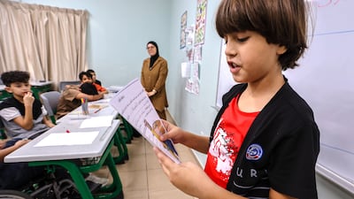 A young Gazan pupil reads out loud to the class
