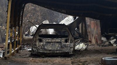 A burnt vehicle is seen inside a gutted house after an overnight bushfire in Quaama in the state of New South Wales, Australia. AFP