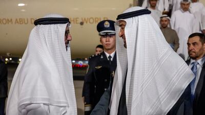 Sheikh Mohamed greets Hussain Al Hammadi, UAE ambassador to China, at the airport.
