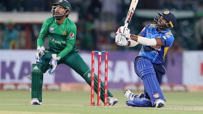 Sri Lankan batsman Bhanuka Rajapaksa hits six as Sarfaraz Ahmed looks on. AP