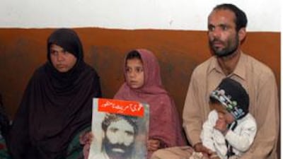 Ghulam Farooq, right, elder son of Ali Asghar Bangulzai, who has been missing for the past two year, talks about his father in Quetta.
