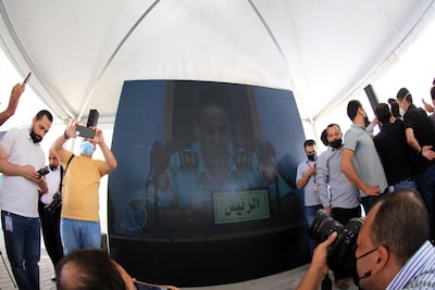 Members of the media watch as a Jordanian court issues a verdict in the case against former royal court chief Bassem Awadallah and a minor royal, Sharif Hassan bin Zaid. EPA