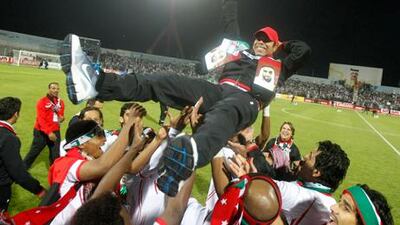 UAE coach Mahdi Ali celebrates with his players after their Gulf Cup victory over Iraq.