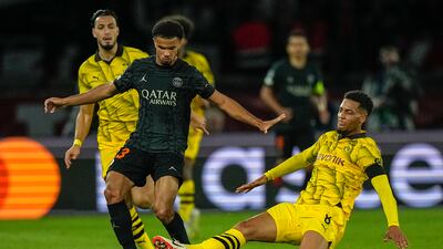 PSG's Warren Zaire-Emery is challenged by Dortmund's Felix Nmecha, right, during their Champions League match last month. AP