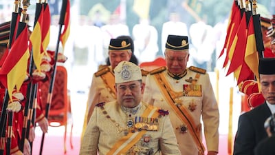 Sultan Muhammad V walks with Malaysian premier Najib Razak, right. Vincent Thian / AP Photo