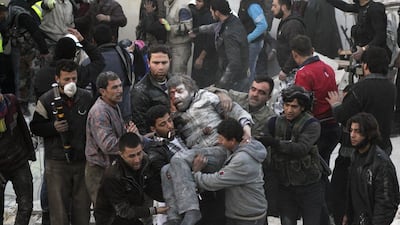 Residents carry an injured man after an air strike from forces loyal to Syria's President Bashar Al Assad in the Takeek Al Bab area of Aleppo. Saad AboBrahim / Reuters
