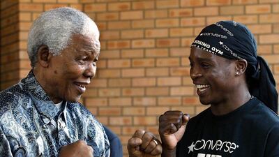 Mandela and boxer Philip Ndouin 2003. AFP