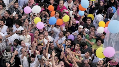 Egyptian release balloons at the end of prayers on the first day of Eid al-Fitr holiday that marks the end of the holy fasting month of Ramadan on June 25, 2017, in the northeastern suburb of Sheraton in the capital Cairo. / AFP PHOTO / SAMER ABDULLAH