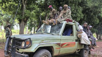 Rebel soldiers and civilians board their vehicle on the road between rebel-held Kaga Bandor oand N'Dele