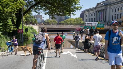 People gather to look at floodwater that continues to rise over the submerged Vine Street Expressway, Interstate 676, following a huge storm caused by the remnants of Hurricane Ida on September 2, 2021 in Philadelphia, Pennsylvania. AFP
