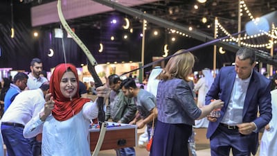 Visitors enjoy the nerf archery booth. Victor Besa / The National
