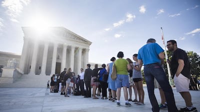 People gathered outside the US supreme court in Washington as the justices prepared to deliver a ruling on president Donald Trump’s travel ban on visitors to the US from six predominantly Muslim countries on June 26, 2017. Jim Lo Scalzo / EPA